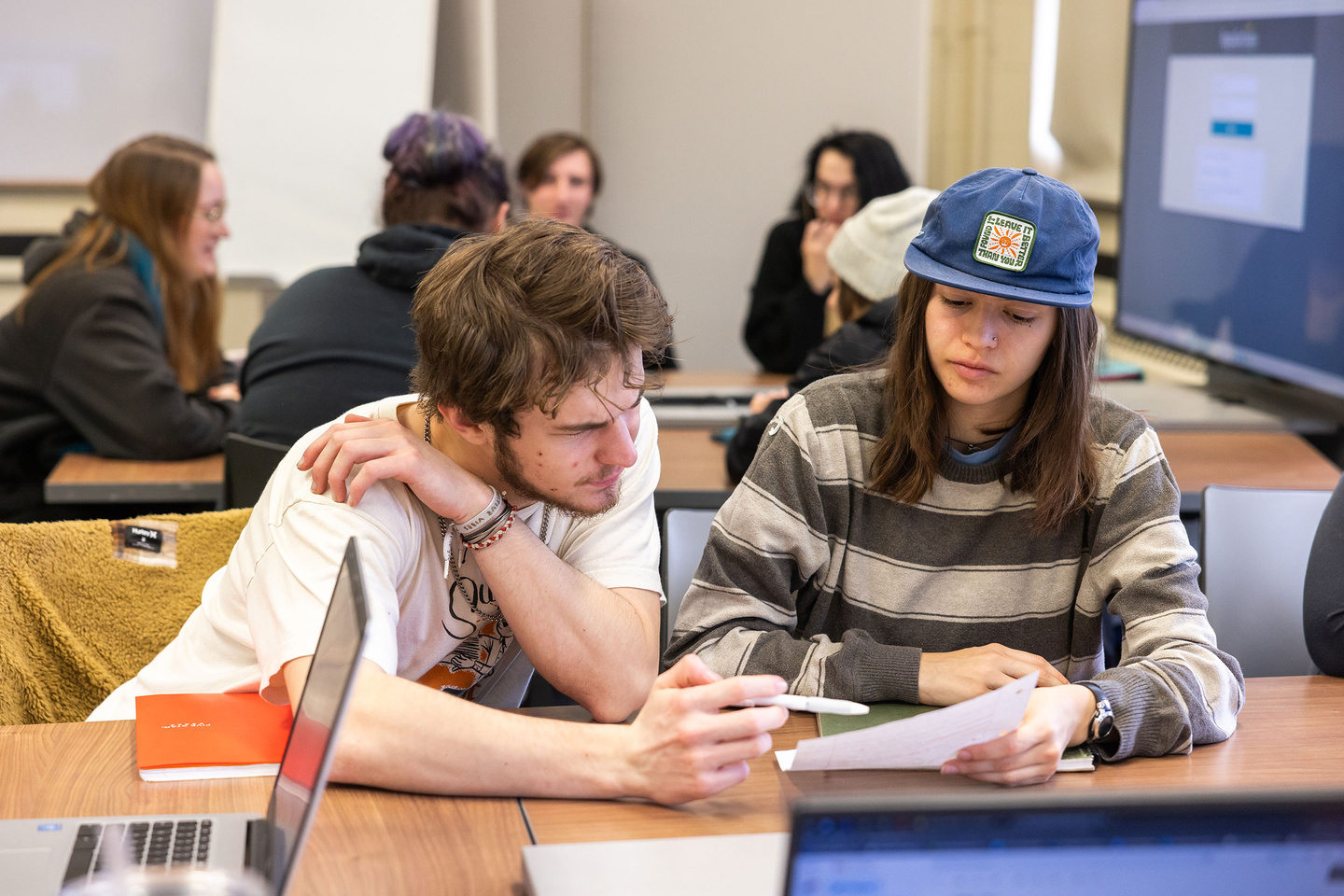 Two students looking at a piece of paper.