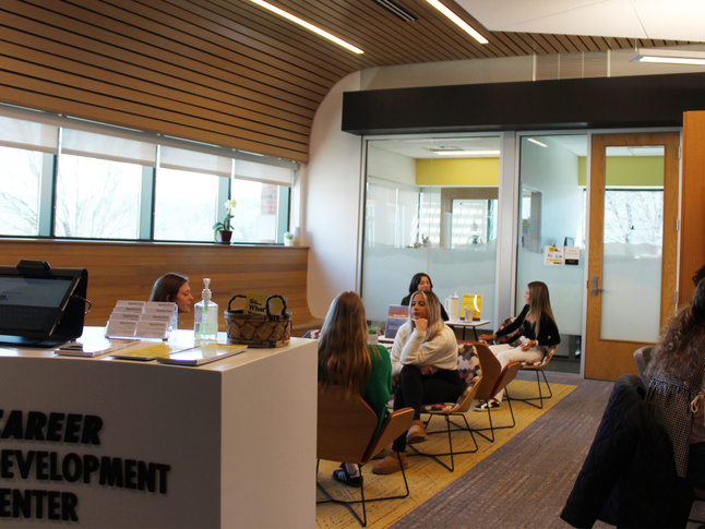 Interior of Career Development Center with several people working at tables in the background.